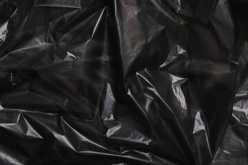 Texture of black plastic bag as background, closeup