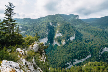 View on the Alps and the mountains of Vercors mountain range from the hiking trail of the Bourne river canyon in the French Alps (Isere)
