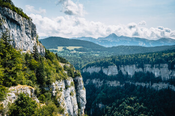 View on the Alps and the mountains of Vercors mountain range from the hiking trail of the Bourne river canyon in the French Alps (Isere) - obrazy, fototapety, plakaty
