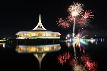 Brightly colorful fireworks in the park on the evening sky background