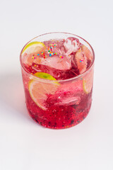 Fancy iced berry lemon soda drink with sprinkle, festive drink for Christmas on white table.