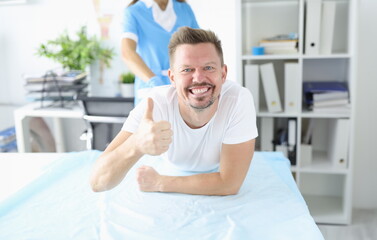 Doctor take test from patient. Happy man lie on couch and show her hand class.