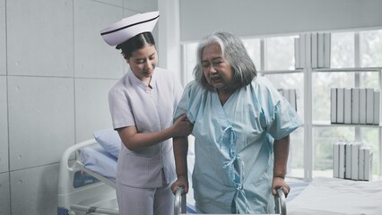 nurse helping senior patient with walker in hospital