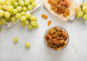 Green sweet dried raisins on light background with ripe grapes.Macro