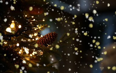Fototapeta na wymiar Spruce branch with pine cone, garland and many glowing lights. Symbol of christmas and new year in foreground.
