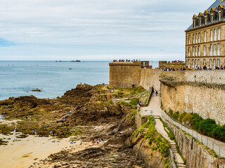 Tourists enjoying the beach surrounding the fortress of Saint Malo during low tide, Brittany, France
- 687457807