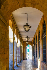 Colonnade, lamps, and windows in a colonial building porch, Oviedo, Spain