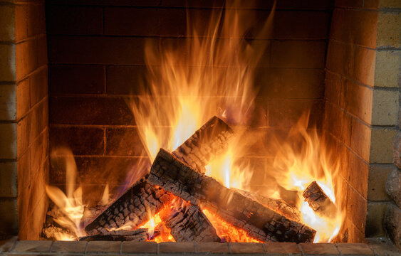 Fire in the fireplace of a country house, cold winter, Christmas, holiday.