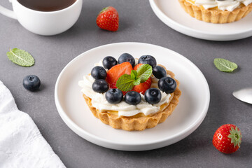 Creamy cheesecake cake with blueberry and strawberries