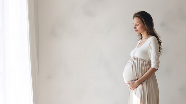 Pregnant woman standing in white room