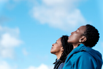 Side portrait of black mature couple enjoying the sun outdoors.