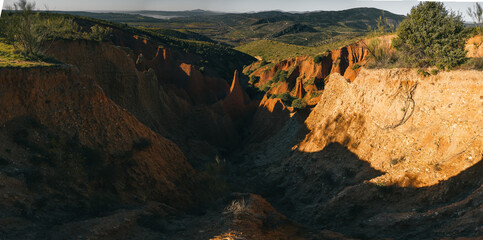 paradise of rock formations with red earth during dawn