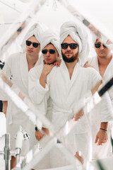 Cheerful men at a spa party in a hotel. Happy men having fun and relaxing at a party. The concept of spa, men's rest and relaxation.