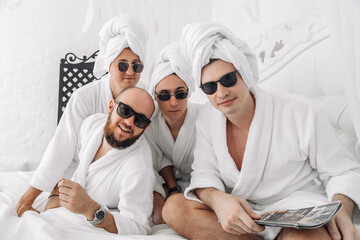 Adult men wearing robe and towel turban enjoying spa day at home. Skin care, spa, relaxation and...
