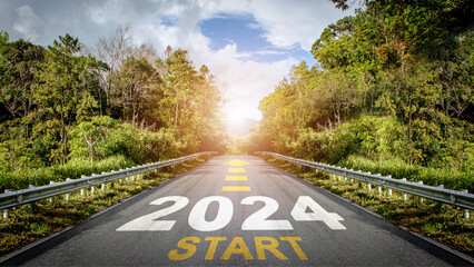 2024 Goals, Plans and Visions concept. Text START 2024 with arrow symbol  written on the road in the middle of asphalt road with at sunset. Business target, planning, challenge, Start of new year. - obrazy, fototapety, plakaty