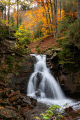 Waterfall in autumn forest with long exposure time