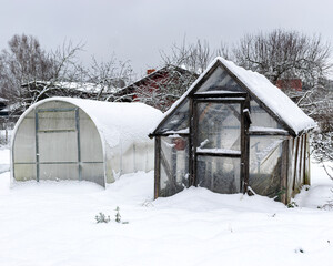 snowy greenhouse with snow, winter day