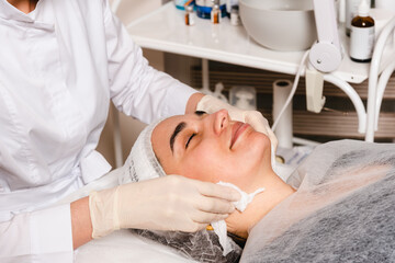 Fototapeta na wymiar Applying a facial mask in a skin care clinic for facial skin elasticity