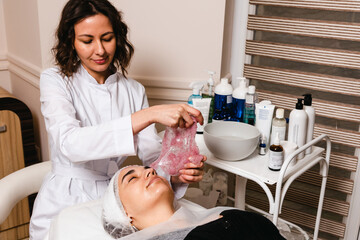 Applying a facial mask in a skin care clinic for facial skin elasticity