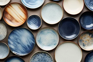 Foto op Plexiglas Various ceramic plates and porcelain dishes in blue, brown, and beige tones, neatly arranged on a white background. Generative AI. © Surachetsh