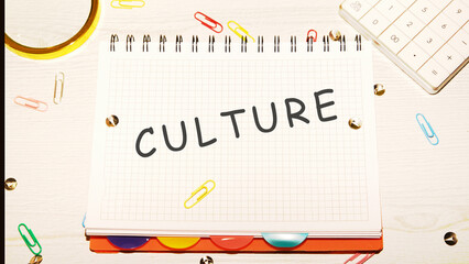 CULTURE word on a checkered notebook on a light table next to a magnifying glass, paper clips,...