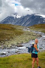 Female hiker hiking up to the glaciers in Norway during summer