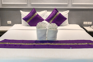Hotel Room Decorated single double bedroom with nice white bed sheets purple decorative colours. the colour scheme is designed for thailand and interior is m modern classical
