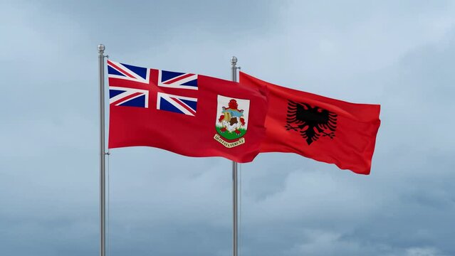 Bermuda flag and Albania flag waving together on cloudy sky, endless seamless loop