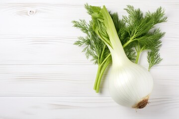 fresh fennel bulb with leaves on wooden table
