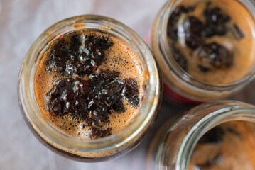 Jars of homemade green grapes jam, view from above