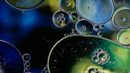Abstract Colorful Food Oil Drops Bubbles and spheres Flowing on Water Surface - 687485411