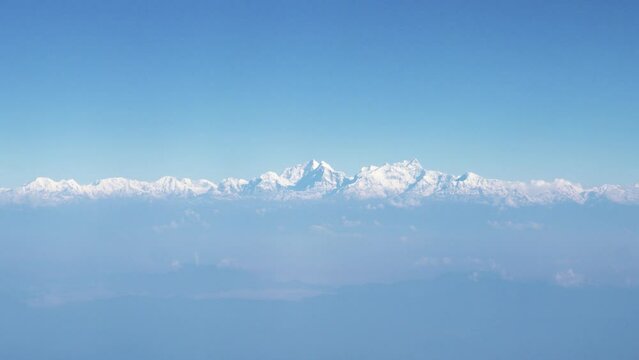 View from the window of a high flying plane on the Himalayan mountain range in Nepal
