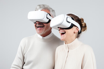 Fototapeta premium A senior couple is smiling while wearing Virtual Reality goggles. Concept for seniors and metaverse.