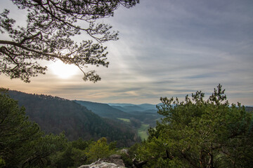 Landscape shot in sunrise, cold winter landscape from a sandstone rock in the middle of the forest. Pure nature in the morning from a viewpoint, the Schlüsselfelsen in the Palatinate Forest, Germany