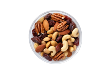 vu de dessus d'un bol rempli d'un assortiment de noix, noix de pécan, cacahouète, noisette, raisins secs et pistache