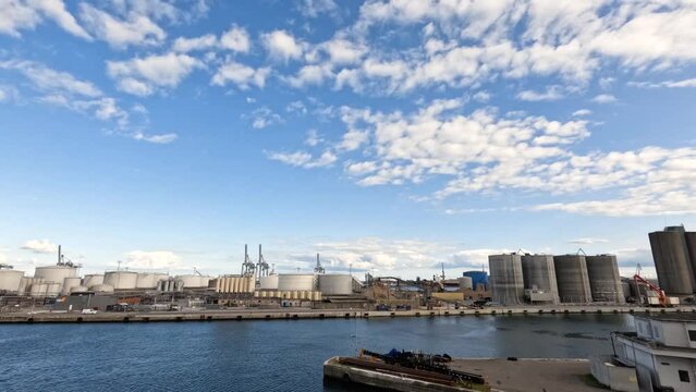 Sky and clouds. Timelapse. Seaport. Timelapse shot of the harbour area with boats and cranes. Blue sky white clouds. Summer blue sky Nature weather blue sky. Cloud time lapse nature background.