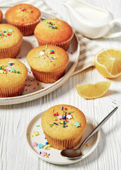 sweet lemon muffins on a plate, top view, close-up