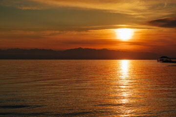 Red sunset over lake in summer