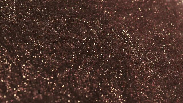 Antique silver. Grunge background molten silver, bronze, copper. Macro video glitter fluid motion. Silver glitters. Shiny background.  Black glitters mixed with silver glitters.