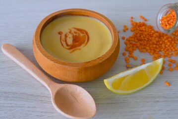 red lentil soup in wooden bowl