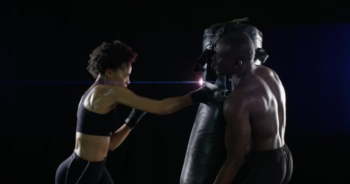 High five, support and motivation for boxing with a black couple in studio on a dark background for health. Success, smile or happy with a man and woman boxer during an exercise workout or training