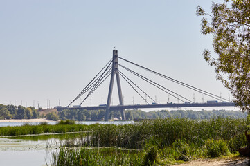 North Bridge in Kyiv, Ukraine. Bridge over the Dnieper river aginst a blue sky background
