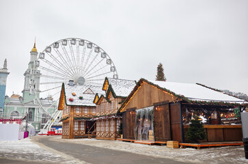 The roof of House Decorated for the Christmas in Europe city. Facade of house for the Christmas Holidays against the backdrop of a ferris wheel