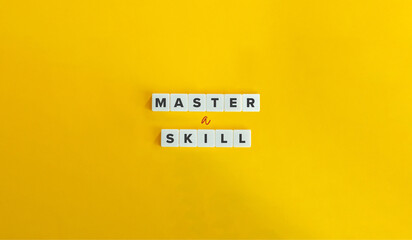 Master a Skill Phrase on Block Letter Tiles on Bright Orange Background. Mastery, Practice, Training Concept.