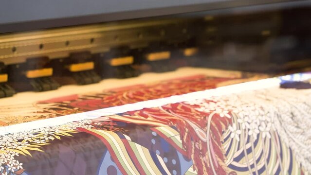 Large Inkjet printer working, industrial printer, plotter head slides over the surface of the paper and prints a large image.