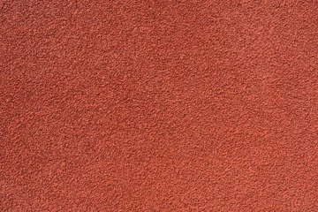 Fotobehang red running tracks textured background, rubber coating for stadiums,  © zhikun sun