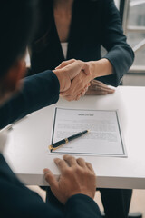 Businessman or job seeker review his resume on his desk before send to finding a new job with pen, necktie, glasses and digital tablet.