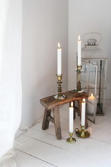 White burning candles in boho room