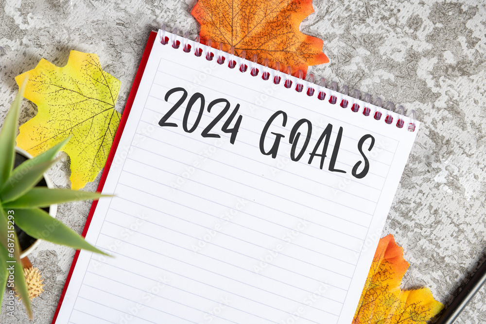 Wall mural Notebook with 2024 goals written on it to make new plans in the new year