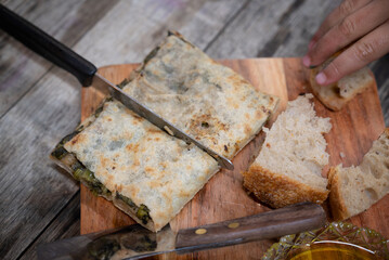 A traditional Fatayer (or Fitir), typical Lebanese pastry, stuffed with spinach and herbs, served...